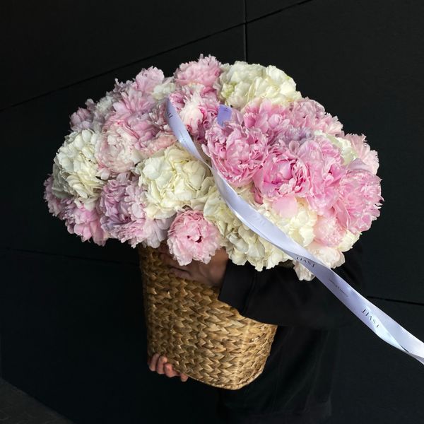 Floral arrangement in a basket based on Dutch hydrangeas and peonies